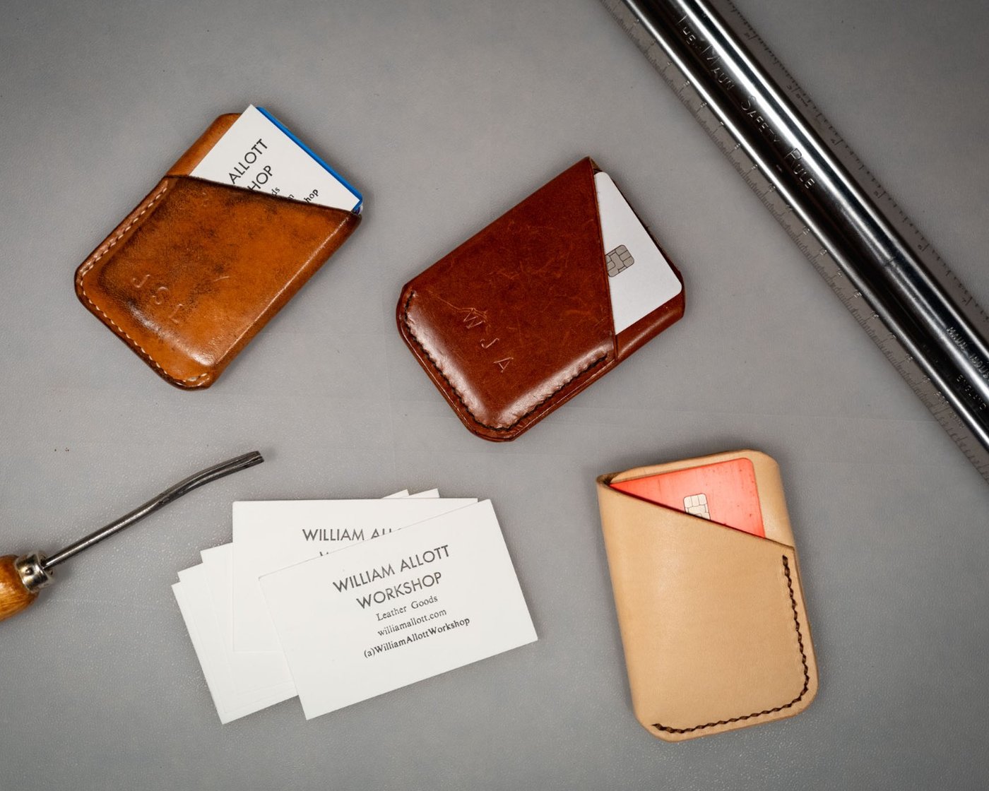 Handmade leather card wallets with embossed initials, and workshop business cards