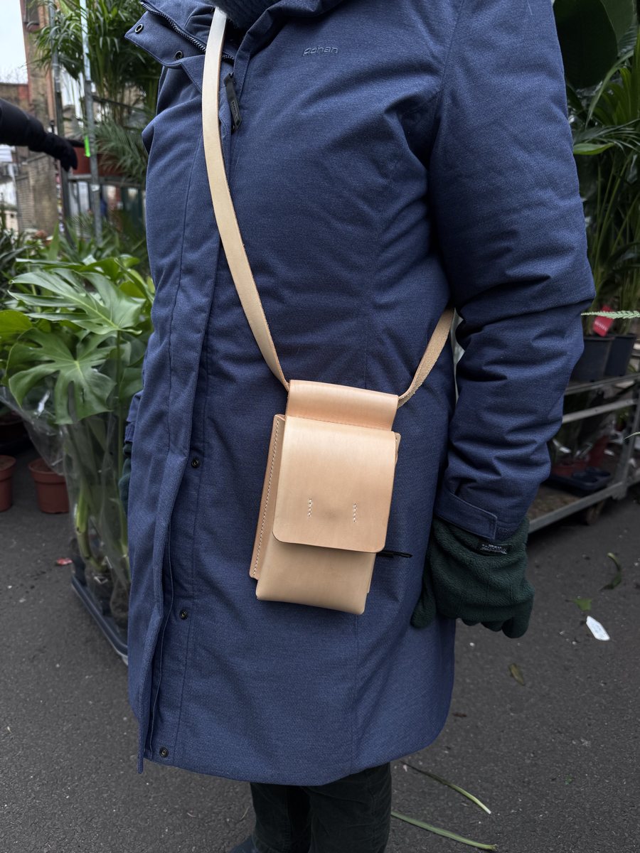 Natural leather shoulder pouch worn across the body