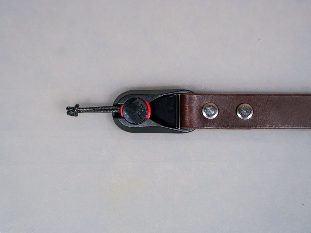 Brown leather camera strap with a Peak Design connector